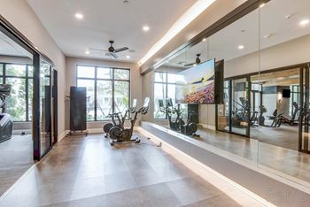A spacious room with a treadmill and a television at Mayla Pompano, Pompano Beach, 33062